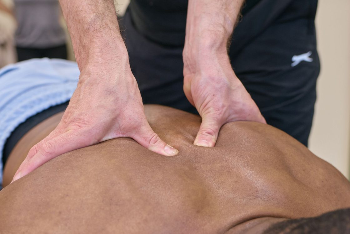 Chiropractor applying spinal pressure to a patient's mid-back at MotionFix, Elephant & Castle