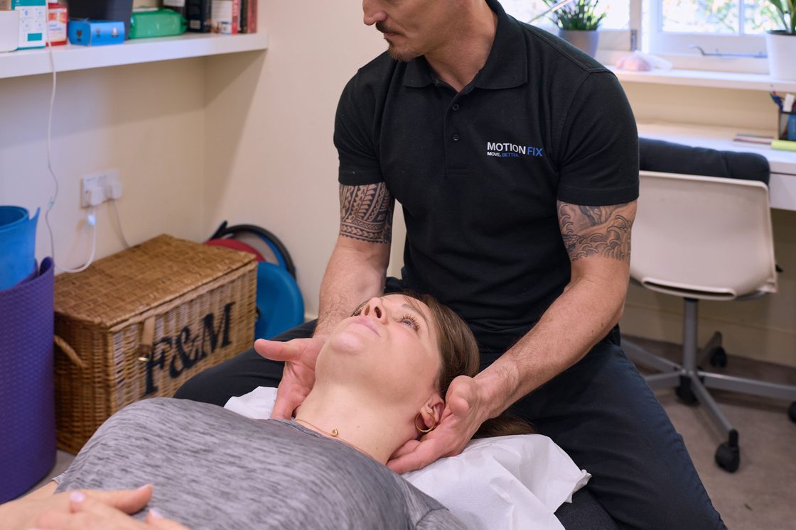 Chiropractor supporting a patient's neck during a cervical adjustment at MotionFix, Elephant & Castle